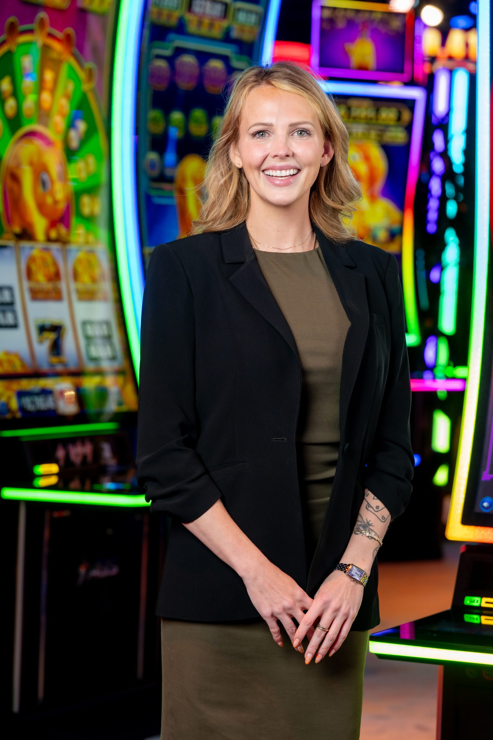 Zoe Ebling, VP of Interactive at AGS, standing in front of slot machines